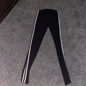 Size small black leggings with two stripes down the side